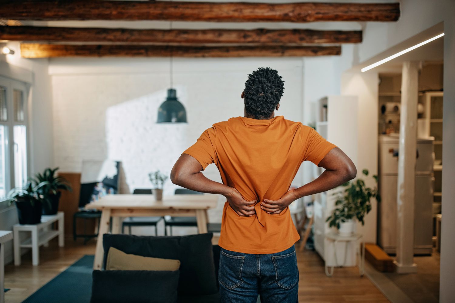 person with axial spondyloarthritis experiencing back pain