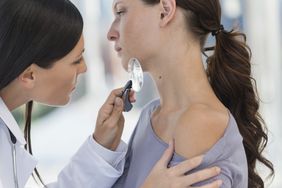 person getting checked for basal cell carcinoma at dermatologist