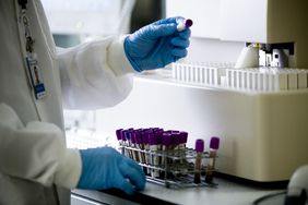 Researcher in lab looking at blood samples