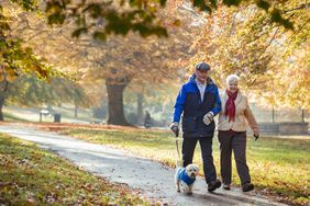 older couple walking their dog to reduce risk of blood clots