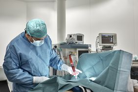 doctor performing bone marrow biopsy