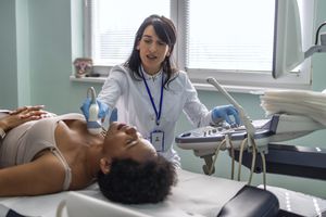 doctor performing ultrasound for breast cancer rash