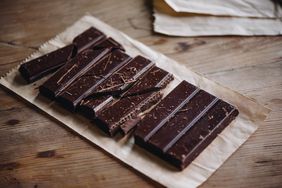 A bar of dark chocolate on a wooden table
