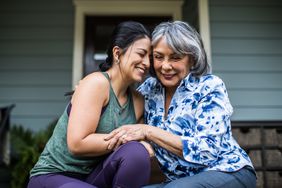 caregiving daughter showing support to mom with dementia