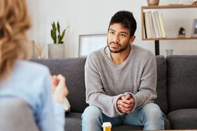 young man receiving therapy from mental health professional 