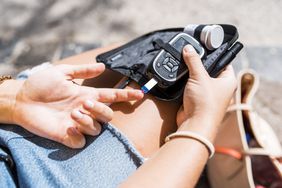 Close up of a young woman checking her blood glucose