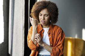 person scratching skin and worsening eczema symptoms