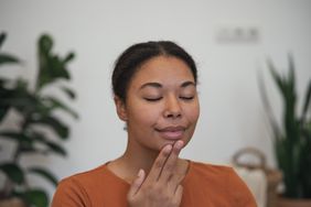 person trying facial tapping with the emotional freedom technique