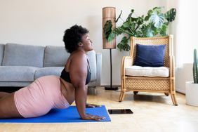 woman doing yoga in living room