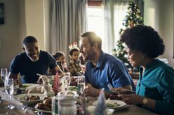 family gathering at table for holiday meal
