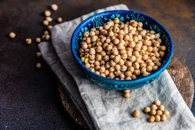 A blue ceramic bowl fill of garbanzo beans (chickpeas)