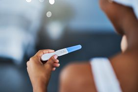 Person holding pregnancy test