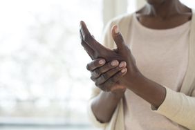 older black woman experiencing complex regional pain syndrome (CRPS) in her hand
