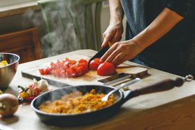 Woman chopping tomatoes