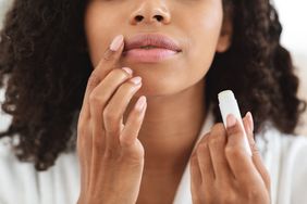 Woman applying chapstick