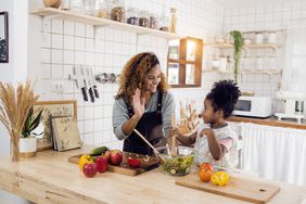 Mother and daughter making a salad