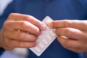 Man Using Nicotine Gum To Quit Smoking. Nicotine Replacement Therapy
