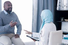 man talking to female doctor about health
