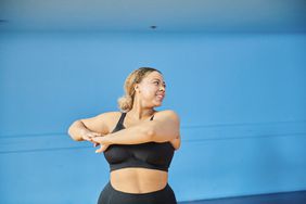 Woman at an indoor exercise class enjoying a workout.