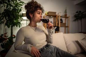 person drinking glass of wine