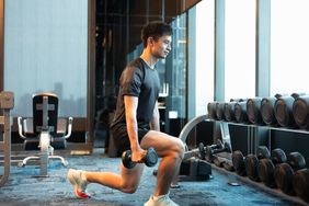 Person doing lunges with dumbbells in the gym