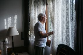Older man looking out the window