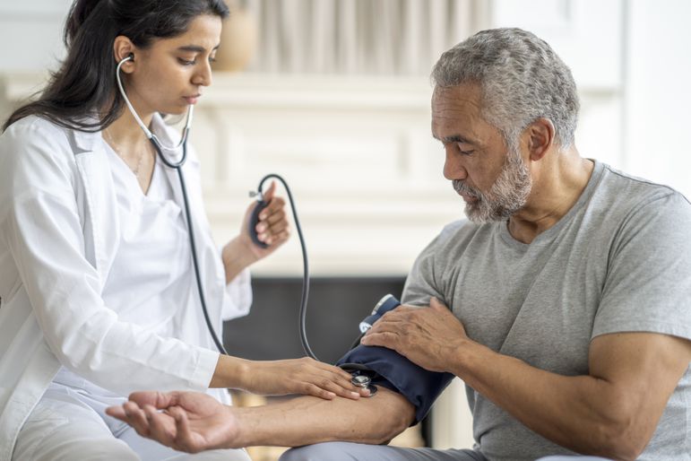 Man getting his blood pressure taken by a doctor. 