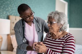 A healthcare provider with a person with Parkinson's disease