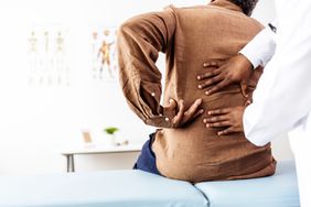 healthcare provider treating patient with back pain