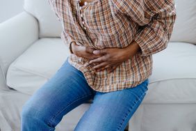 Woman clutching her stomach