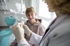 Teenager at dentist office getting clear aligners for teeth