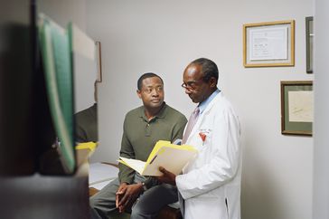 doctor discussing prostate biopsy results with man