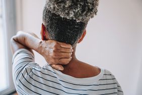 person holding neck