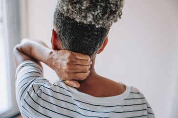 person holding neck