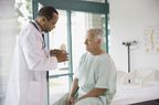 Doctor explaining anatomical model to patient in hospital
