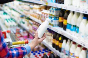 Woman looking at milk bottle
