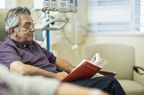 Patient reading book in infusion room 