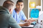 male healthcare provider talking to male patient