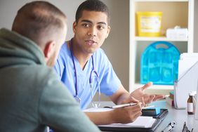 male healthcare provider talking to male patient
