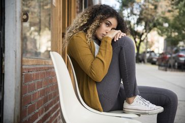 Nervous and anxious woman on a bench avoiding activity