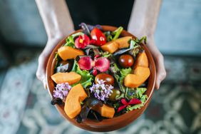 Man holding salad.