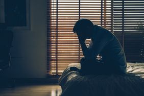 Man sitting head in hands headache thunderclap