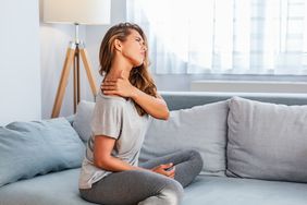 person sitting on the couch experiencing collarbone pain