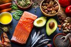 salmon, avocado, sardines, nuts on a table