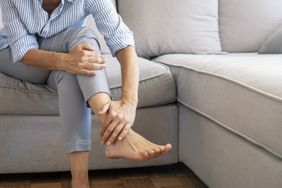 person experiencing foot cramps