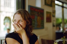 Woman covering her mouth. 