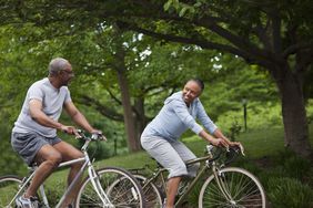 two elderly adults riding bikes