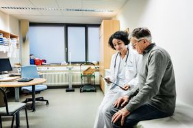 female doctor talking to male patient