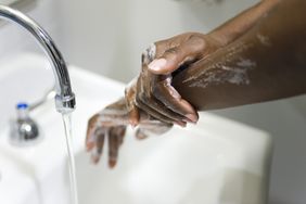 woman washing her hands to help prevent a cold