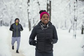Woman running outside in the snow.